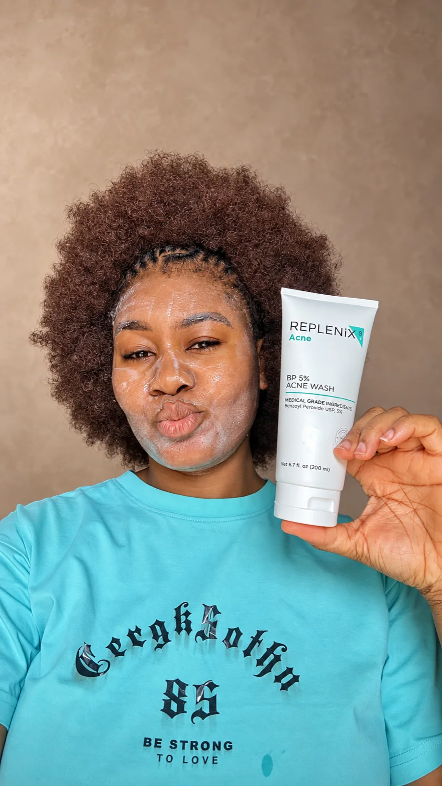 Cynthia holding a skincare cleanser