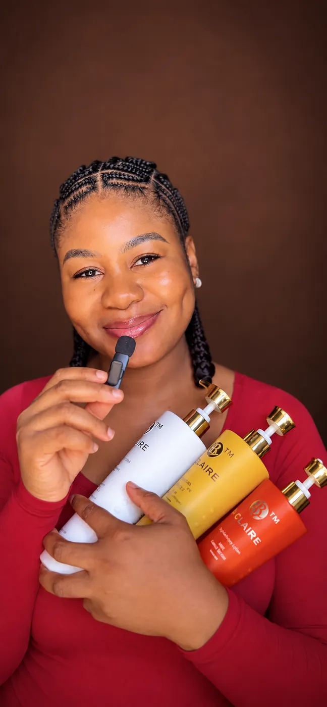 Cynthia speaking into a small microphone while holding a selection of skincare products
