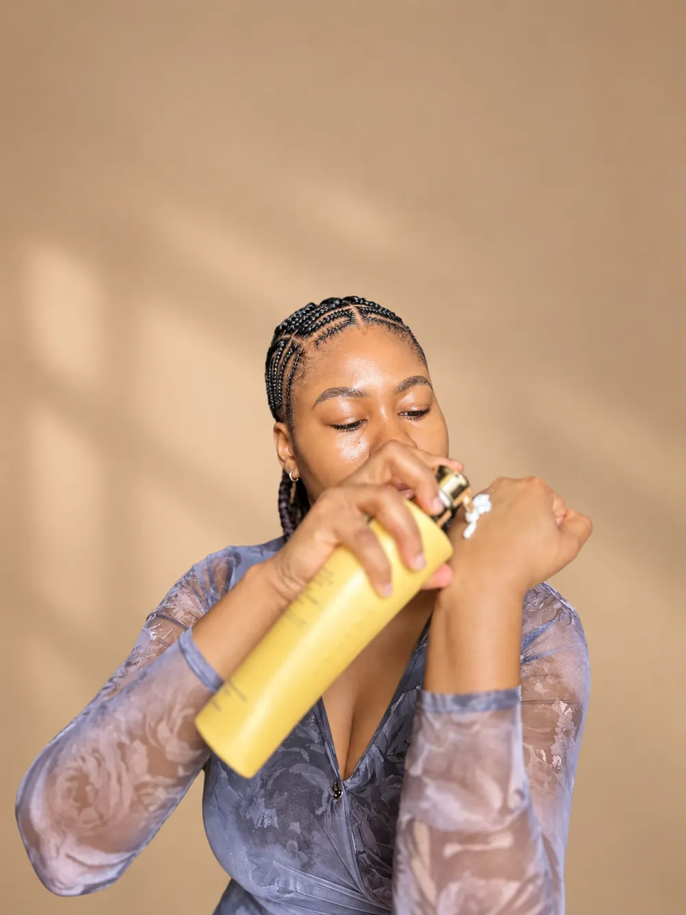 Cynthia applying a skincare mist during her routine